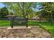 W.H. Ferguson Park sign with gazebo, green grass and trees in background at 2654 Forest St, Denver, CO 80207