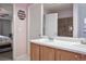 Bathroom featuring double sinks, maple cabinets, and an adjoining room with tile shower at 11844 Oak Hill Way # A, Commerce City, CO 80640