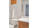 A bright bathroom with a wooden sink cabinet and a white towel hanging on the rack at 11844 Oak Hill Way # A, Commerce City, CO 80640