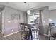 Cozy dining area with stylish bar-height table and chairs, alongside a decorative wine rack at 11844 Oak Hill Way # A, Commerce City, CO 80640
