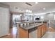 Kitchen with island, sink, dishwasher, and view into dining area at 11844 Oak Hill Way # A, Commerce City, CO 80640