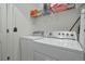 Laundry room with a white washer and dryer, plus shelving for storage at 11844 Oak Hill Way # A, Commerce City, CO 80640