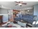 Spacious living room with L-shaped sectional sofa and ceiling fan at 11844 Oak Hill Way # A, Commerce City, CO 80640