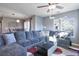 Comfortable living room with a large sectional sofa, modern coffee table, and natural light at 11844 Oak Hill Way # A, Commerce City, CO 80640