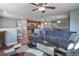 Open-concept living room with a fireplace, sectional sofa, modern coffee table and view of the kitchen at 11844 Oak Hill Way # A, Commerce City, CO 80640