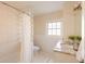 Well-lit bathroom with a shower-tub combo and granite countertops on the vanity at 5555 E 17Th Avenue Pkwy, Denver, CO 80220