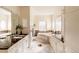 Luxurious bathroom with marble countertops, a soaking tub, and bright natural light at 5555 E 17Th Avenue Pkwy, Denver, CO 80220