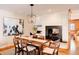 Dining room featuring a modern chandelier, a large fireplace, and an attached workspace at 5555 E 17Th Avenue Pkwy, Denver, CO 80220