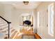 Bright entryway features hardwood floors, staircase and arched doorway leading to the living spaces at 5555 E 17Th Avenue Pkwy, Denver, CO 80220