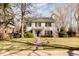 Charming two-story home with landscaped yard, symmetrical design, and classic architectural details at 5555 E 17Th Avenue Pkwy, Denver, CO 80220