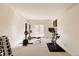 Bright home gym with exercise equipment and French doors leading to the backyard at 5555 E 17Th Avenue Pkwy, Denver, CO 80220