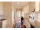 Hallway with hardwood floors and white cabinets at 5555 E 17Th Avenue Pkwy, Denver, CO 80220