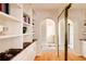 Hallway with built-in shelves and a mirrored closet, offering ample storage space at 5555 E 17Th Avenue Pkwy, Denver, CO 80220