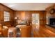 A cozy living room with wood paneled walls and a fireplace, featuring warm, natural light at 5555 E 17Th Avenue Pkwy, Denver, CO 80220