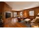 Cozy living room with wood-paneled walls and a view into an adjacent breakfast area at 5555 E 17Th Avenue Pkwy, Denver, CO 80220