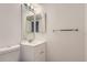 Bathroom featuring a vanity with granite countertops and double mirrors at 6475 S Dayton St # 102, Englewood, CO 80111