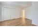 Bedroom featuring new wood floors and spacious closet for ample storage at 6475 S Dayton St # 102, Englewood, CO 80111