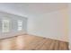 Bedroom with light hardwood floors and two windows at 6475 S Dayton St # 102, Englewood, CO 80111