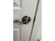 Close-up of a brushed steel door handle and lock on a white door, showing secure and modern hardware at 6475 S Dayton St # 102, Englewood, CO 80111