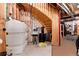 Unfinished basement with exposed utilities, wood stairs and framing, and water filtration system at 8002 Galileo Way, Littleton, CO 80125