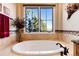 Bathroom featuring a standalone tub under a large window with natural light at 8002 Galileo Way, Littleton, CO 80125