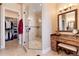 Bathroom featuring a glass shower, vanity with marble countertop, and walk-in closet at 8002 Galileo Way, Littleton, CO 80125