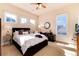 Bedroom with carpet floors, natural light, a Queen bed, and side tables at 8002 Galileo Way, Littleton, CO 80125