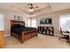 Bedroom featuring a tray ceiling, a King bed, carpet floors, and neutral decor at 8002 Galileo Way, Littleton, CO 80125