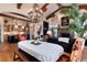 Open dining area showcasing an elegant chandelier, wood beams, and open access to kitchen at 8002 Galileo Way, Littleton, CO 80125