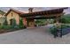 Elegant gated entrance to the Ravenna community with stone accents, manicured landscaping, and a welcoming sign at 8002 Galileo Way, Littleton, CO 80125