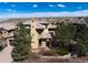 Stunning Mediterranean home with a red tile roof and lush, mature landscaping at 8002 Galileo Way, Littleton, CO 80125