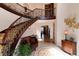 Grand foyer with a curved staircase, elegant decor, and natural light at 8002 Galileo Way, Littleton, CO 80125