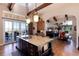 Kitchen with island, bar seating, granite countertops, and open layout to living area at 8002 Galileo Way, Littleton, CO 80125