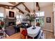 Inviting living area with stone fireplace, hardwood floors, and lots of natural light at 8002 Galileo Way, Littleton, CO 80125