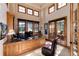 Bright home office with natural wood finishes and multiple windows at 8002 Galileo Way, Littleton, CO 80125