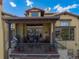 Covered patio with tile flooring, comfortable seating, a gas grill, and outdoor dining area at 8002 Galileo Way, Littleton, CO 80125