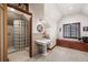 Bathroom featuring a glass block shower and pedestal sink at 1563 N Lafayette St, Denver, CO 80218