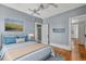 Blue themed primary bedroom with hardwood floors and artwork at 1563 N Lafayette St, Denver, CO 80218