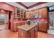 Charming kitchen featuring custom cabinetry, a center island, granite countertops, and stainless steel appliances at 1563 N Lafayette St, Denver, CO 80218