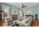 Charming living room with fireplace, hardwood floors, and natural light from large windows at 1563 N Lafayette St, Denver, CO 80218