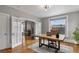 Bright office features a wooden desk, hardwood floors, and large windows at 1563 N Lafayette St, Denver, CO 80218