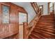 Classic wooden staircase with detailed banister leading to the upper levels, complemented by stained glass windows at 1563 N Lafayette St, Denver, CO 80218