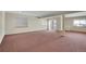 Unfinished basement with carpeted floor and sliding door at 23405 E Elmhurst Pl, Aurora, CO 80016