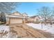 Two-story house with beige siding, stone accents, and a three-car garage at 23405 E Elmhurst Pl, Aurora, CO 80016