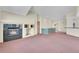 Living room with a fireplace and views into the kitchen and dining areas at 23405 E Elmhurst Pl, Aurora, CO 80016