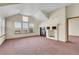 Living room with vaulted ceiling, fireplace, and carpet flooring at 23405 E Elmhurst Pl, Aurora, CO 80016