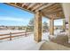 Covered patio with view of snowy landscape at 23405 E Elmhurst Pl, Aurora, CO 80016