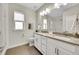 Bright bathroom features dual sinks, modern lighting, and a glass-enclosed shower, offering a clean and elegant design at 11150 E 26Th Ave, Aurora, CO 80010