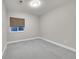 Neutral-toned bedroom with carpeted floors, a window, and simple decor, ideal for creating a relaxing retreat at 11150 E 26Th Ave, Aurora, CO 80010