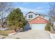 Two-story brick home with attached two-car garage and landscaping at 458 Whitetail Cir, Lafayette, CO 80026